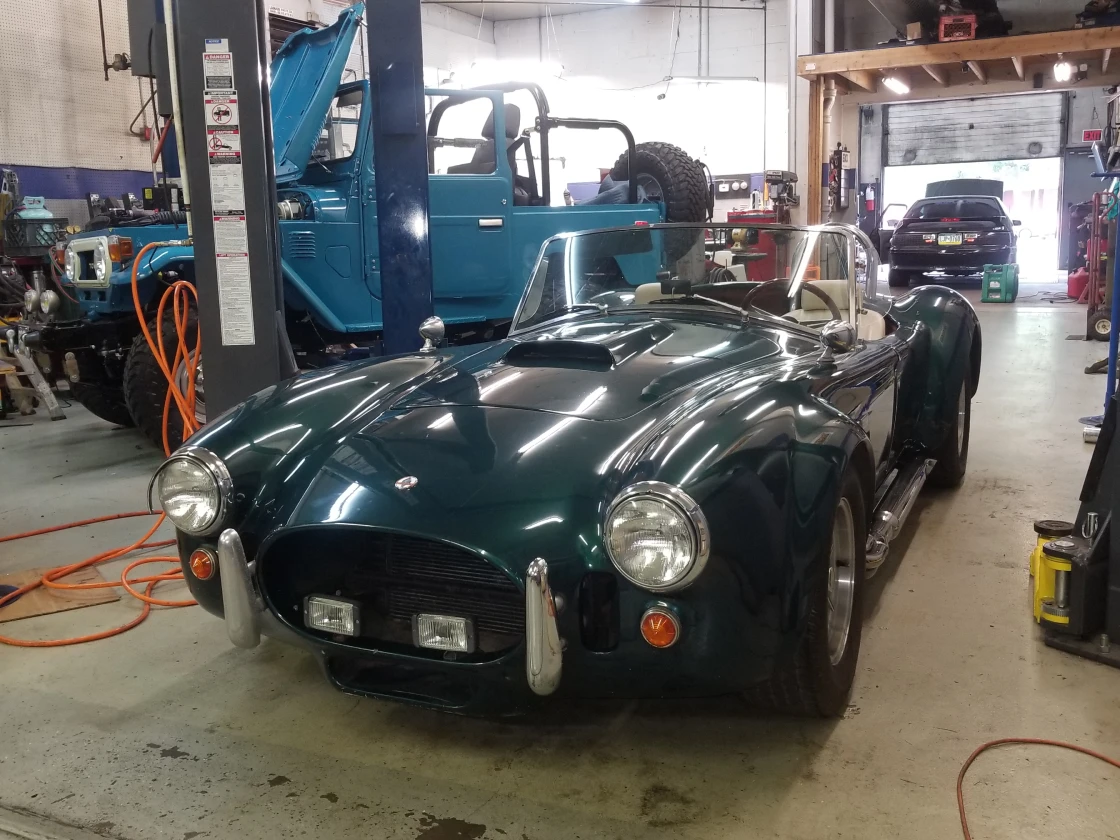 Classic Green Sports Car in the shop 1 Classic Green Sports Car in the shop 1